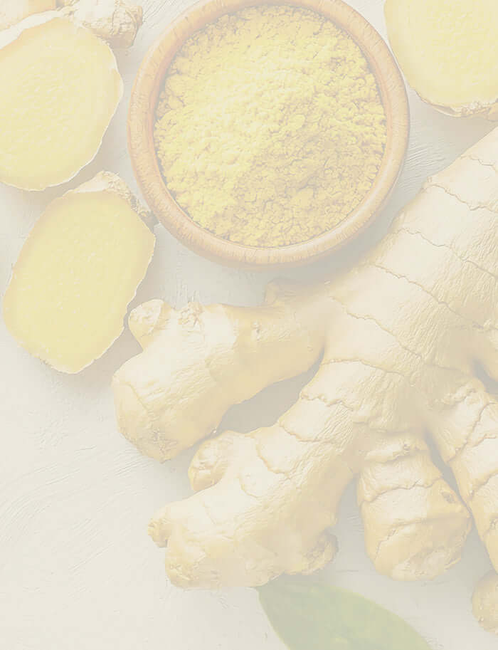 Golden ginger root and ground ginger, highlighting its warming properties for essential oil use.