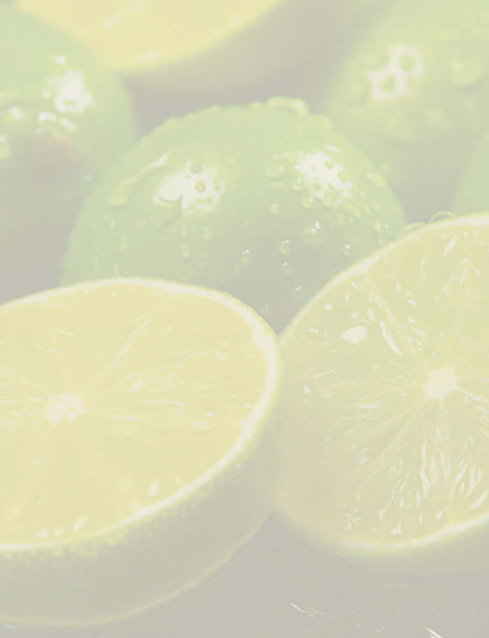 Close-up of ripe limes, showcasing their vibrant green colour and juicy texture, a key ingredient for Lime essential oil.