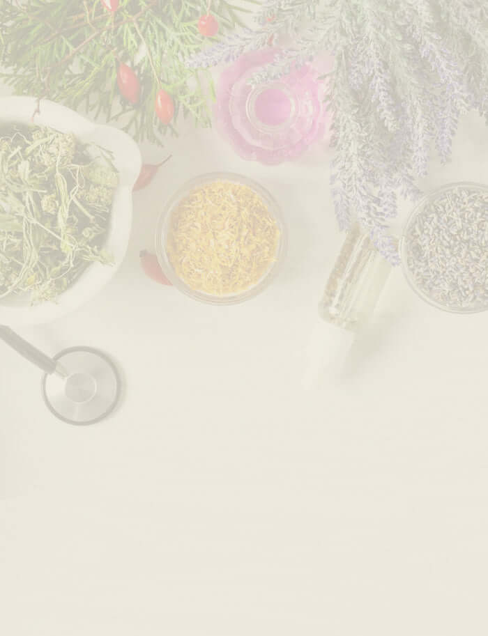 Herbal remedies with dried flowers, essential oils, and a mortar and pestle.