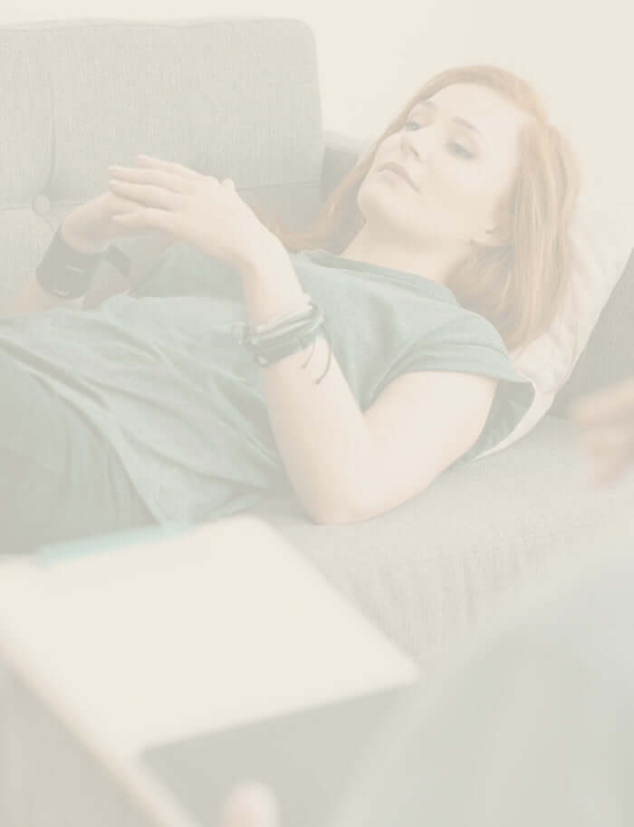 A hypnotherapist guiding a client through a relaxation session.