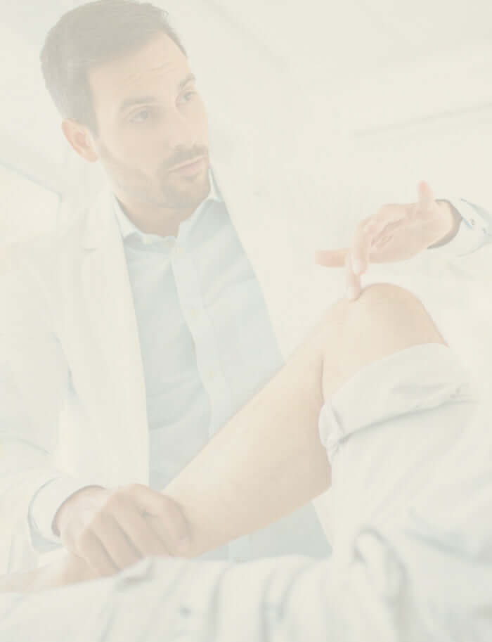 Naturopath assessing a patient's joint health during consultation.