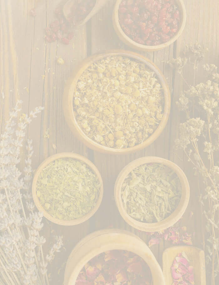 Wooden bowls filled with dried herbs and flowers, representing the natural benefits of herbal supplements for health and wellness