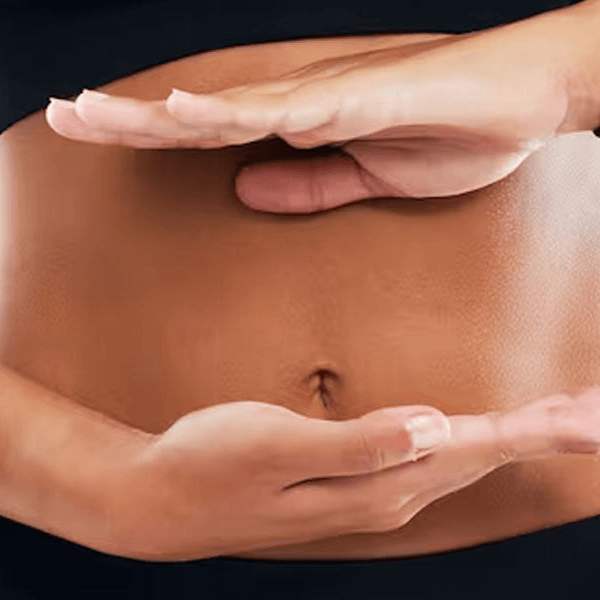 A woman holding her hands horizontally across her stomach