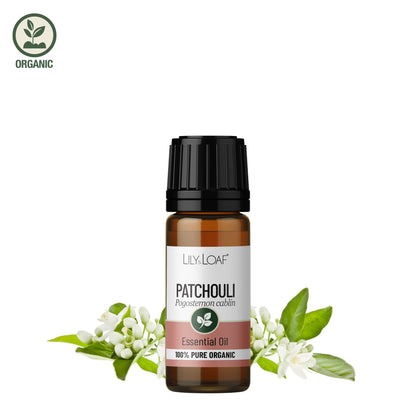Patchouli Essential Oil bottle with fresh patchouli flowers