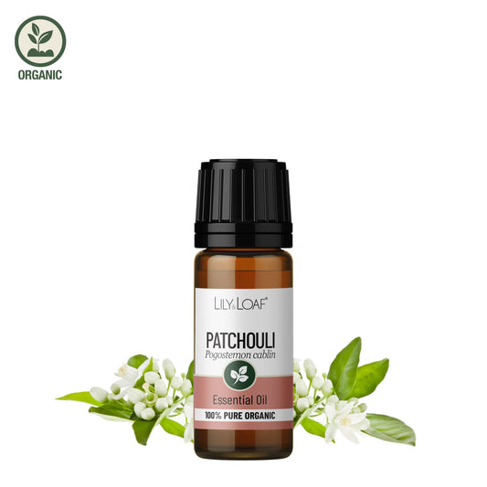 Patchouli Essential Oil bottle with fresh patchouli flowers
